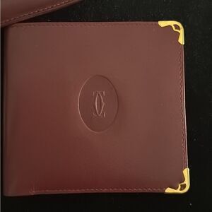 Never used Cartier red burgundy wallet comes with original box